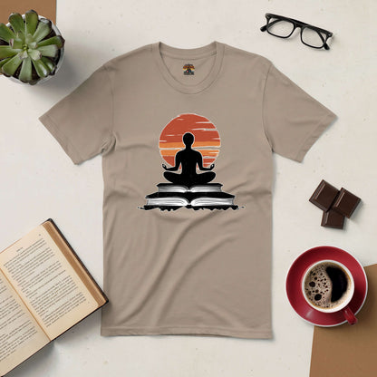 Connection Established Tee featuring meditation design with books, surrounded by coffee, glasses, chocolate, and plant on a table.