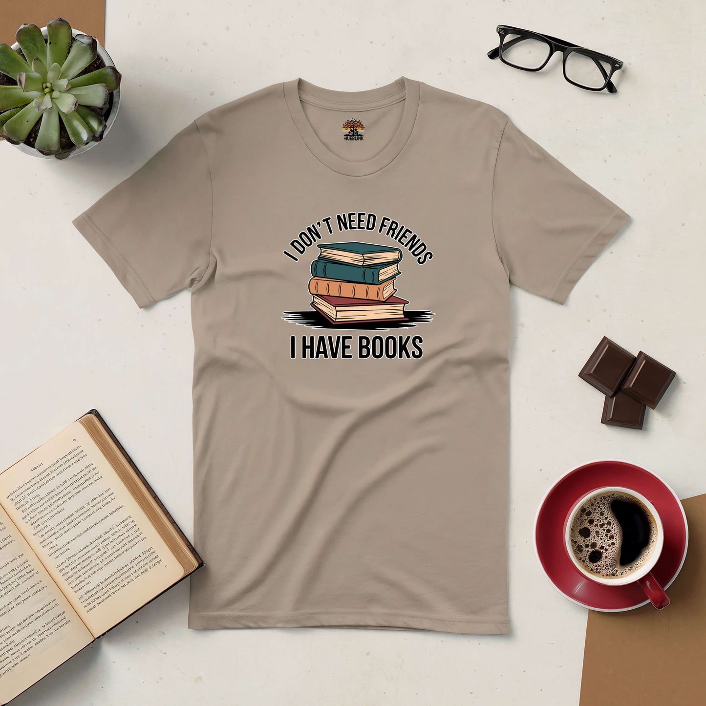 "I Don't Need Friends, I Have Books Tee for book lovers and introverts, surrounded by coffee, chocolate, and an open book."