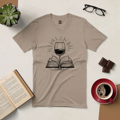 Literary Libations tee with wine glass and book design, surrounded by coffee, chocolate, and reading accessories.