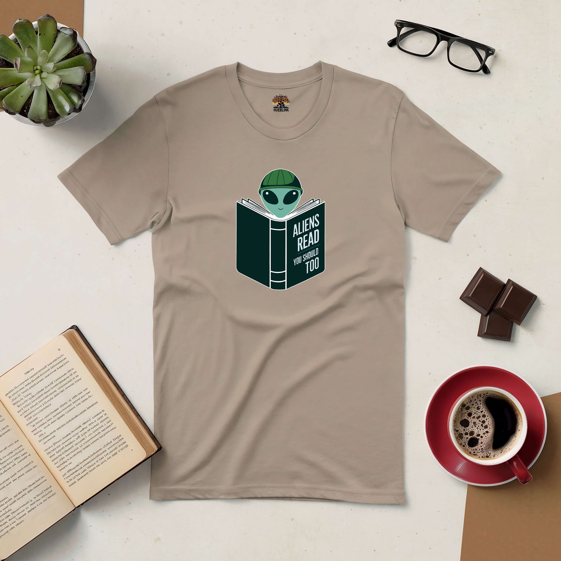 Intergalactic Habit Tee with alien reading design, perfect for book lovers and sci-fi fans.