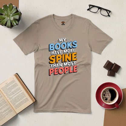 T-shirt with 'My Books Have More Spine Than Most People' design, surrounded by coffee, glasses, chocolate, and a book.