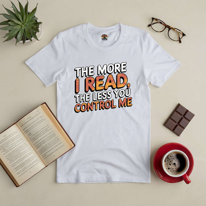 White t-shirt with text "The More I Read, The Less You Control Me" surrounded by book, coffee, chocolate, and glasses.