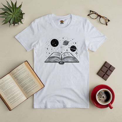 "Journey Through Space Tee with book and galaxy design, perfect for book lovers and space enthusiasts, displayed with coffee and book."