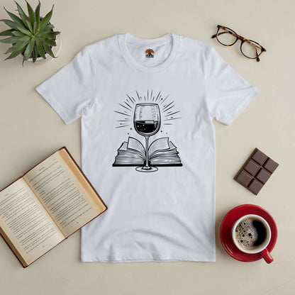 Literary Libations Tee with wine and book graphic surrounded by coffee, chocolate, open book, plant, and glasses.