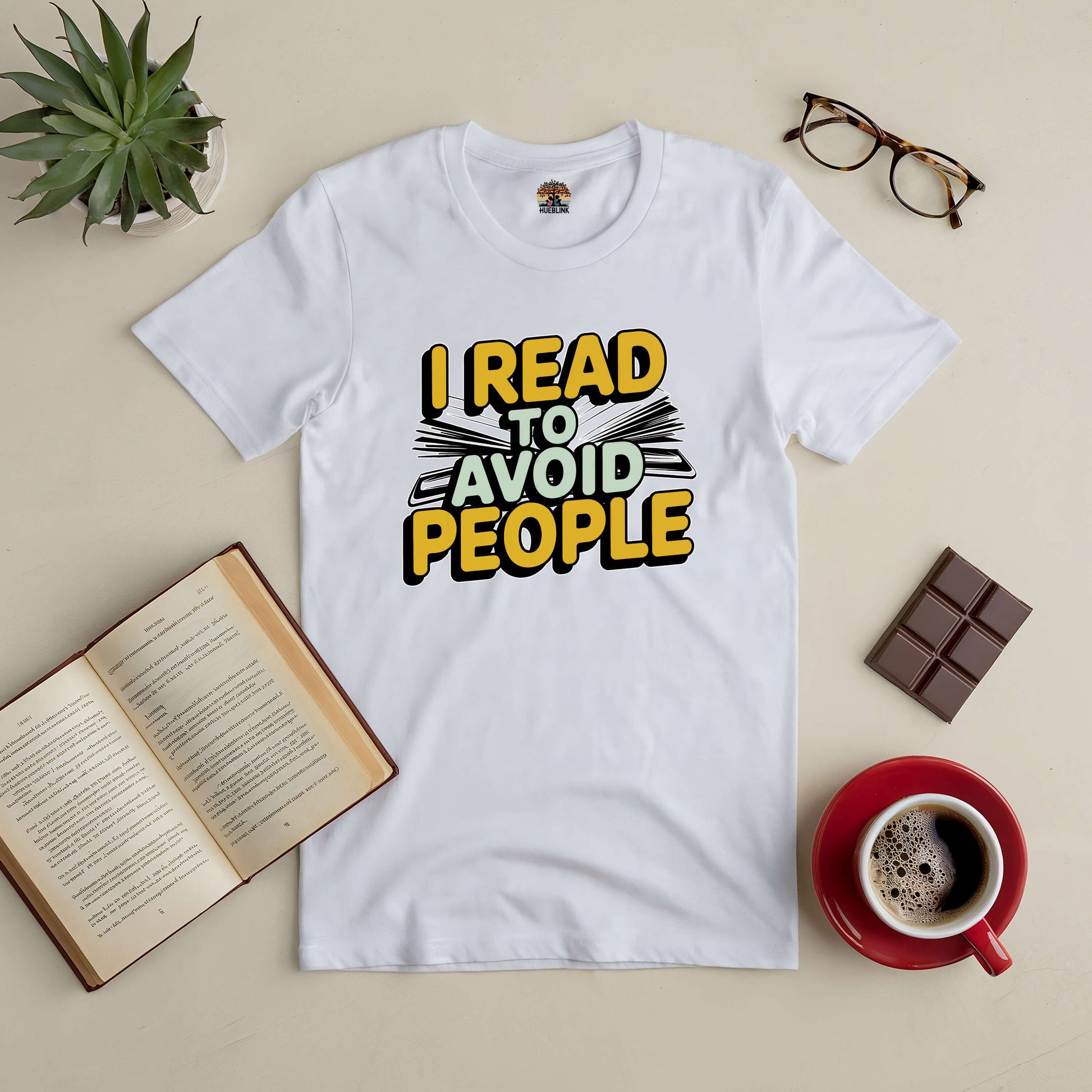 "I Read To Avoid People Tee for book lovers, featuring bold text. Perfect for introverts who prefer reading over small talk."