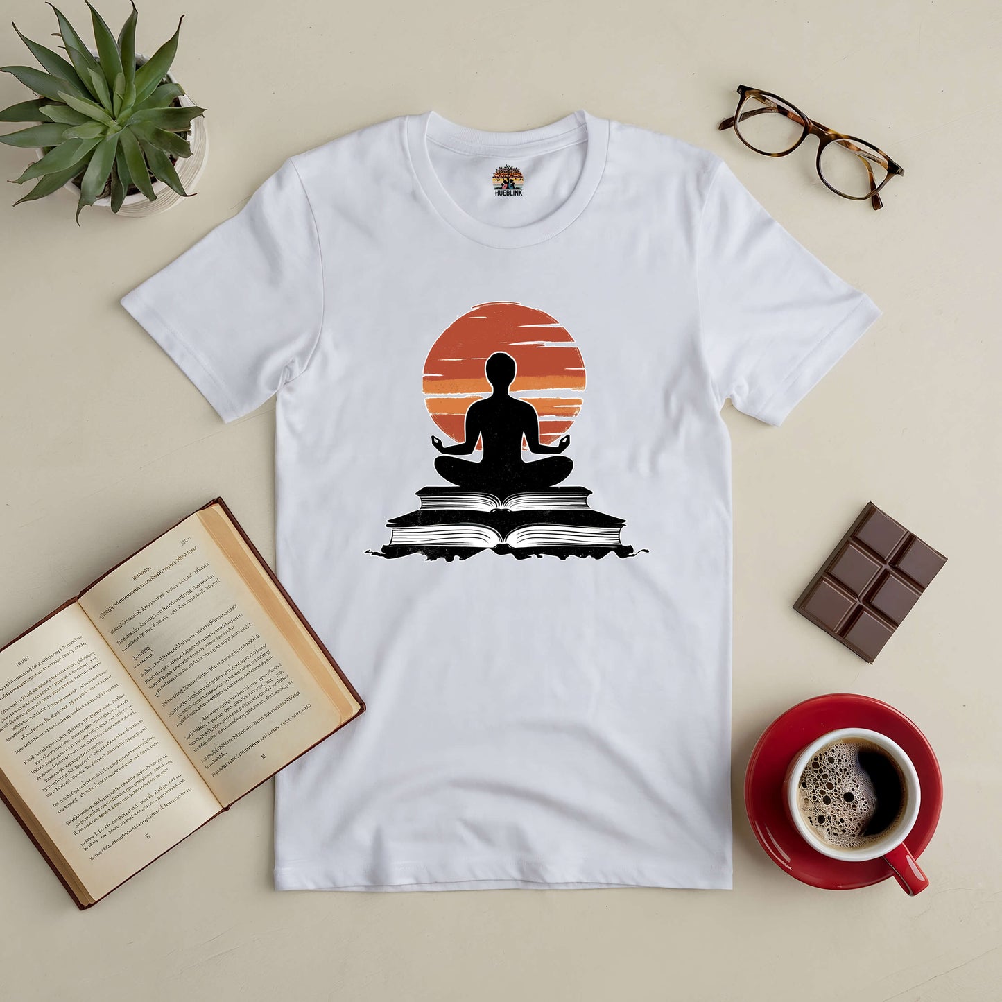 White "Connection Established" tee with meditative figure, open book, coffee, glasses, and plant, symbolizing peace and wisdom.